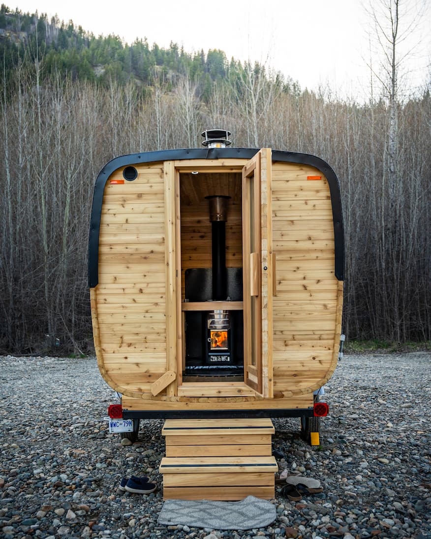 Exterior of the Ophir sauna, showing the wood bench and stove inside