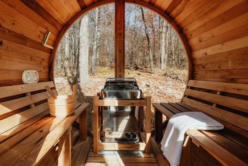 Sauna interior with wood stove and bench seating